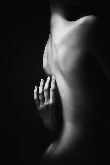 innuendo. the graceful brush of a young girl bending slightly touches her bare back with her fingers