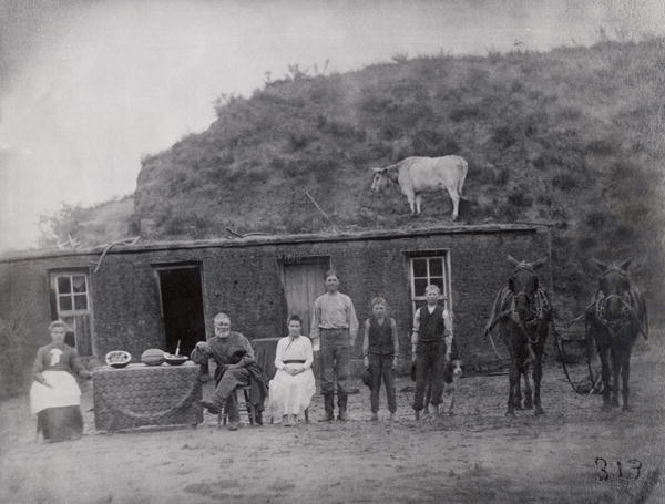 American pioneer family in front of their home (b/w photo)  from American Photographer