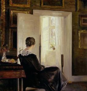 A woman seated near a door