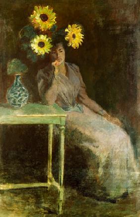 Sedentary woman next to a vase with sunflowers