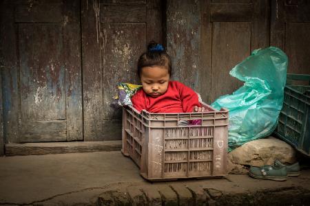 Babysitting in the market at Bhaktapur, Nepal