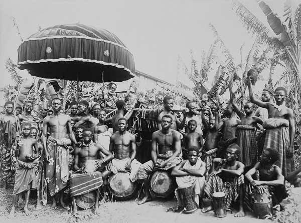 Ashantee King Carried by Slaves under State Umbrella Surrounded by Followers, c.1890 (b/w photo)