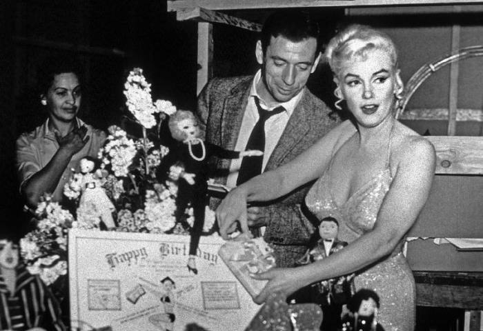 French Actor Yves Montand, American Actress Marilyn Monroe and a birthday cake. from English Photographer, (20th century)