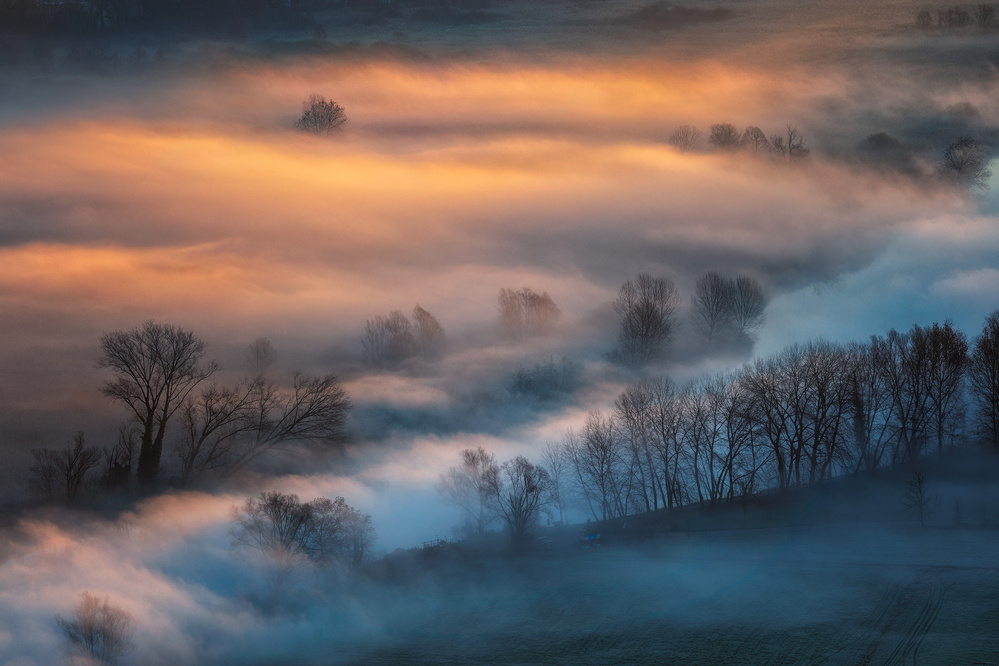 Sunrise light in the foggy valley from Fiorenzo Carozzi