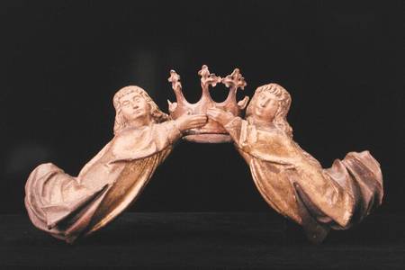 A pair of flying angels supporting a crown from German School