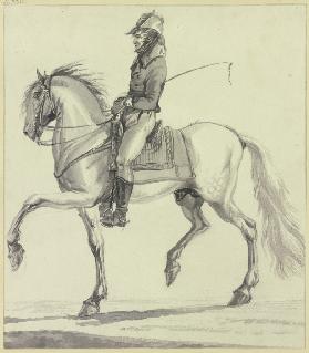 A whipper-in on horseback
