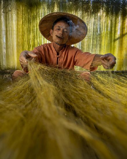 A fisherman preparing his nets ready for the next Catch