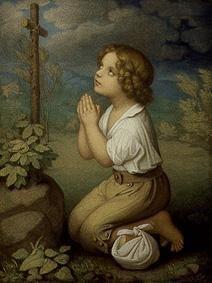 Praying boy at the wayside cross.