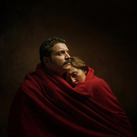 The couple under the red cloth