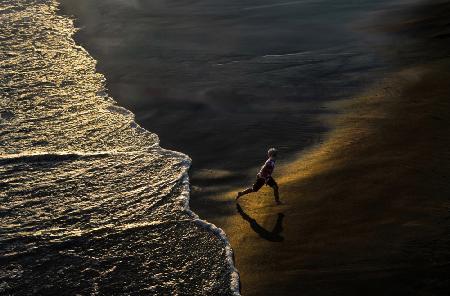 Boy Running On The Beach