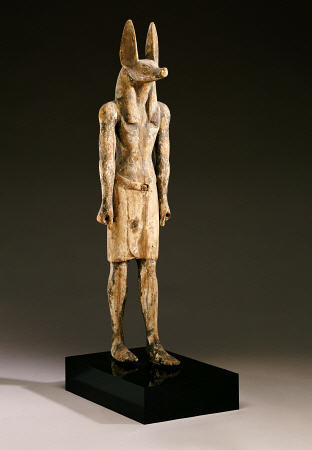 An Egyptian Wood Figure Of A Jackal-Headed Deity from 