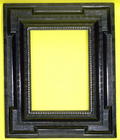 Alpine 17th century carved and ebonised frame with a projecting plane, inset extended corners and va