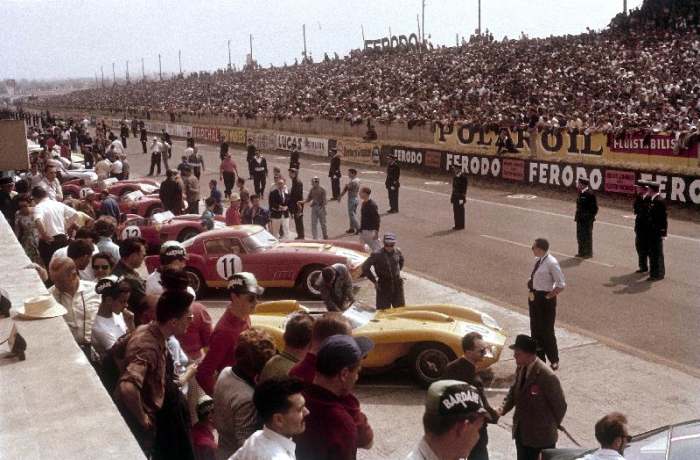 Le Mans racing circuit, France. The cars are lined up in the pits, with the spectator stands opposit from 