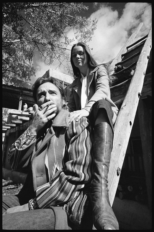 Dennis Hopper and wife Michelle Phillips on a ladder in New Mexico from Orlando Suero