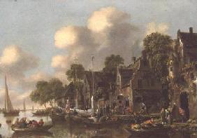 A river landscape with boats and figures by a tavern
