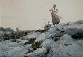 Young woman on rocks standing.
